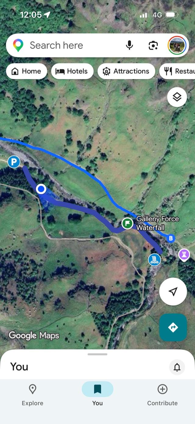 A phone displaying the Google Maps app with a walk route highlighted and a location marker showing the walker's position